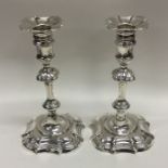 A good pair of George II cast silver candlesticks