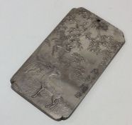 A heavy rectangular silver ingot decorated with an