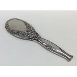 A stylish silver hand mirror decorated with flower