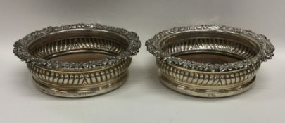 A pair of attractive Georgian silver wine coasters