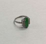 An Art Deco jade and diamond nine stone ring in pl