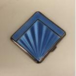 An Art Deco silver and blue enamel cigarette case.