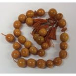 A good string of cylindrical yellow amber beads. A