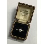A platinum set diamond single stone ring in claw m
