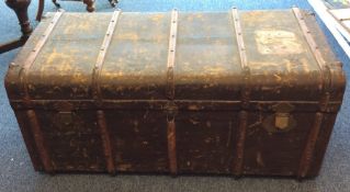A massive canvas trunk with leather handles. Est.