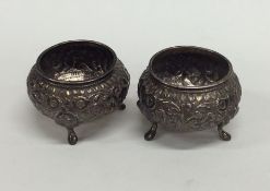 A pair of Indian silver salts embossed with scroll