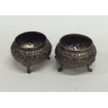 A pair of Indian silver salts embossed with scroll