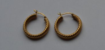 A pair of 9 carat hoop earrings of twisted design.