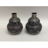 A pair of Persian silver and enamel bulbous shaped