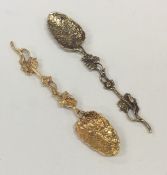 A matched pair of silver gilt teaspoons with leaf