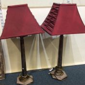 A large pair of plated lamps together with shades.