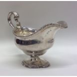 A Georgian Adams' style silver cast sauce boat wit