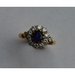 A sapphire and diamond circular cluster ring set i