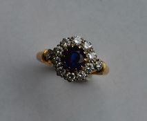 A sapphire and diamond circular cluster ring set i
