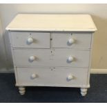 A pine chest of four drawers on turned supports. E