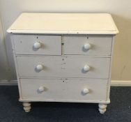 A pine chest of four drawers on turned supports. E