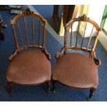 A pair of Victorian nursing chairs with spindle ba