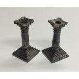 A pair of Corinthian column candlesticks. Est. £30