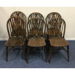 A set of six oak wheel back chairs with stretcher