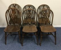 A set of six oak wheel back chairs with stretcher