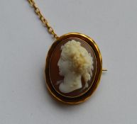 A small gold mounted shell cameo of a lady. Approx