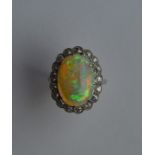 A large cushion shaped opal and diamond oval clust