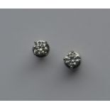 A pair of cased diamond single stone ear studs in