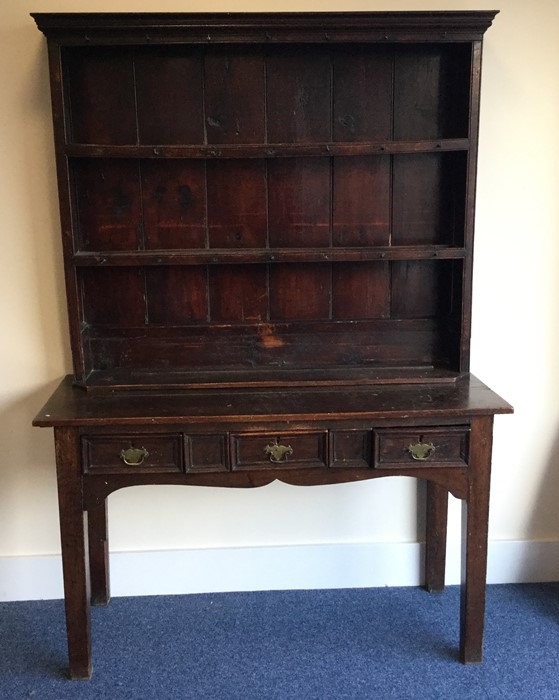 A tall three drawer oak dresser with plank back. E