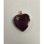 A large enamelled pendant in the form of a heart w