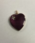 A large enamelled pendant in the form of a heart w