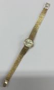 A 9 carat lady's wristwatch on mesh strap retailed