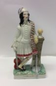 A tall Staffordshire figure of a gentleman on squa