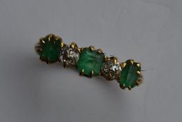 A large emerald and diamond five stone ring in gol