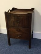 A Georgian mahogany commode with hinged front. Est