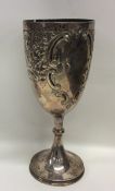 A large embossed silver goblet decorated with flow