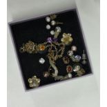 A box containing gold and other earrings. Est. £20