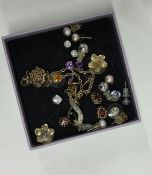 A box containing gold and other earrings. Est. £20