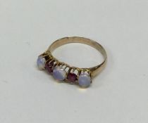 A ruby and opal five stone ring in 18 carat gold c