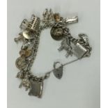 A heavy silver curb link charm bracelet with heart