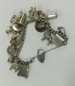 A heavy silver curb link charm bracelet with heart