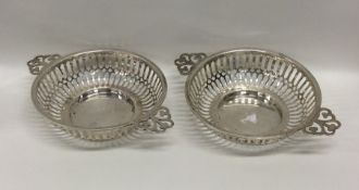 A pair of circular pierced fluted silver sweet dis