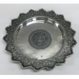 An Eastern silver and Niello shallow dish on ball