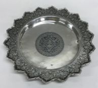 An Eastern silver and Niello shallow dish on ball