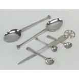 Three silver cruet spoons together with a paper kn