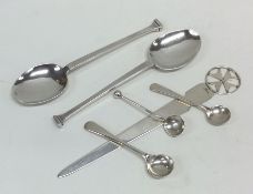 Three silver cruet spoons together with a paper kn