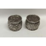 A heavy pair of cast Indian silver salts with scro