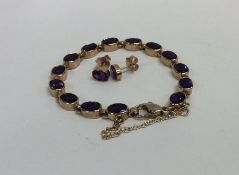 A 9 carat amethyst bracelet with safety chain toge