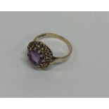 An amethyst single stone ring in claw mount. Appro