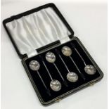 A cased set of six silver bean top coffee spoons.
