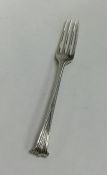 A Georgian silver fork with tapering scroll handle